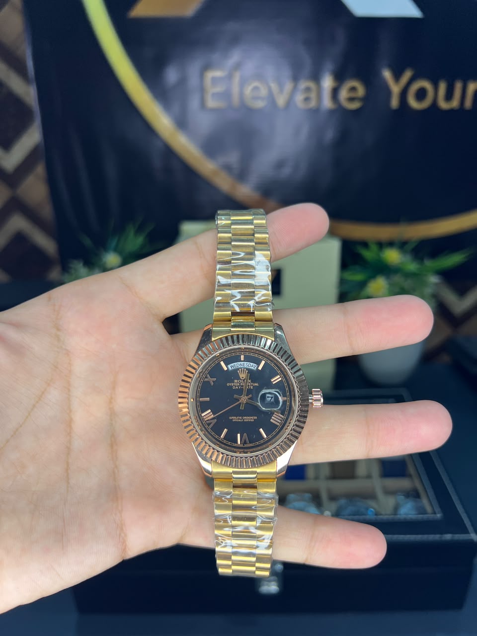 Rolex Day-Date yellow gold black dial President bracelet – held in hand